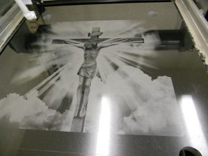 Christ on a cross etched gravestone