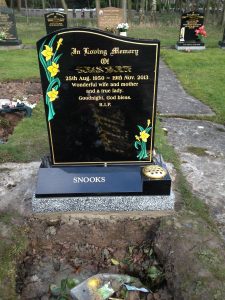 headstone with daffodils