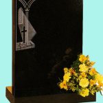 Square polished black gravestone with church window design