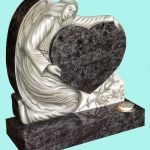 Beautiful carved angel holding a heart headstone