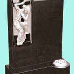 Elegant black granite headstone with lady and cross carving