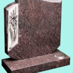 Unique headstone shape with carved flowers