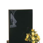 Black gravestone with church window detail
