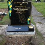 headstone with daffodils